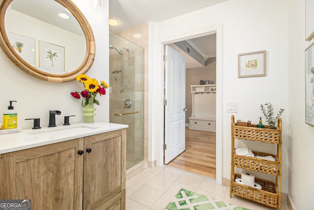 bathroom with vanity, wood-type flooring, and a shower with shower door