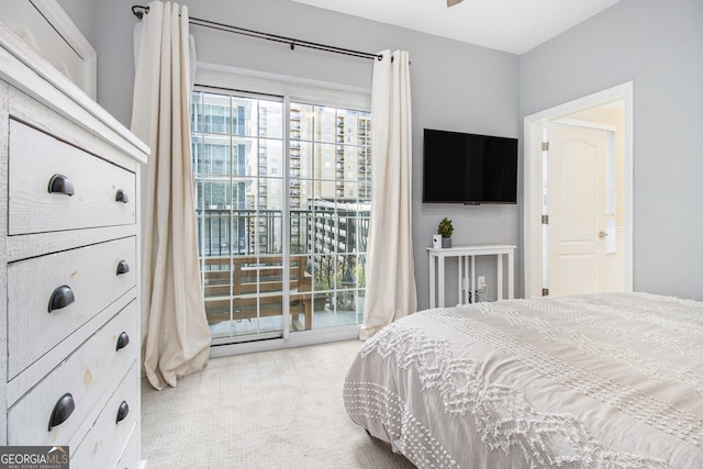 bedroom with access to outside and light colored carpet