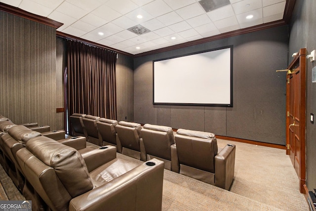 carpeted home theater room with crown molding