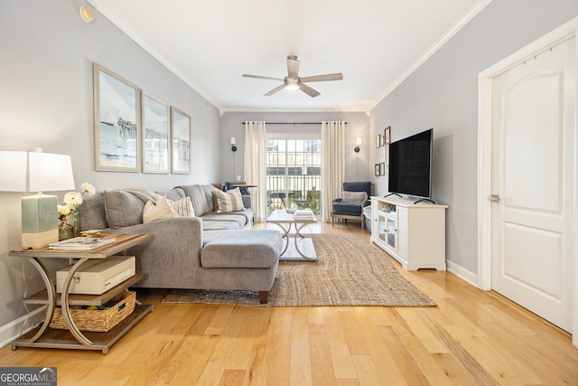 living room with light hardwood / wood-style floors, ceiling fan, and crown molding