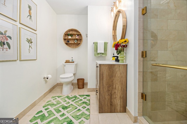 bathroom with tile patterned floors, vanity, toilet, and a shower with door