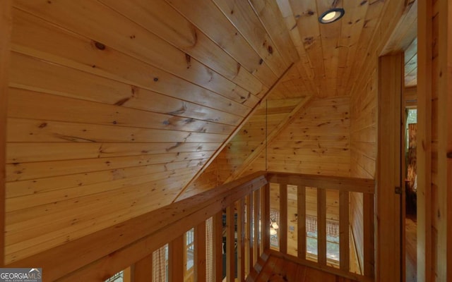 bonus room with wooden ceiling, vaulted ceiling, and wooden walls