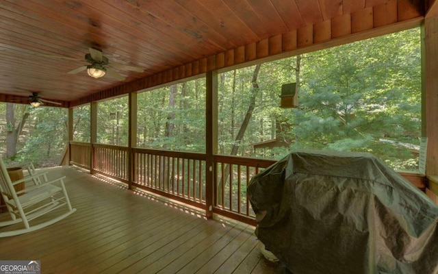 wooden terrace with a grill and ceiling fan