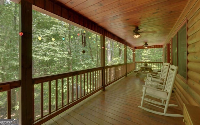 wooden deck featuring a porch and ceiling fan