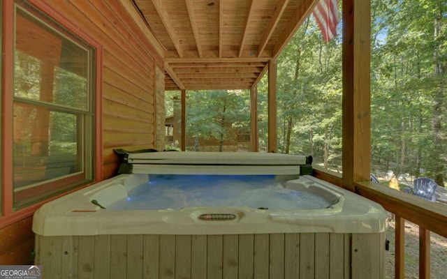 wooden deck with a hot tub