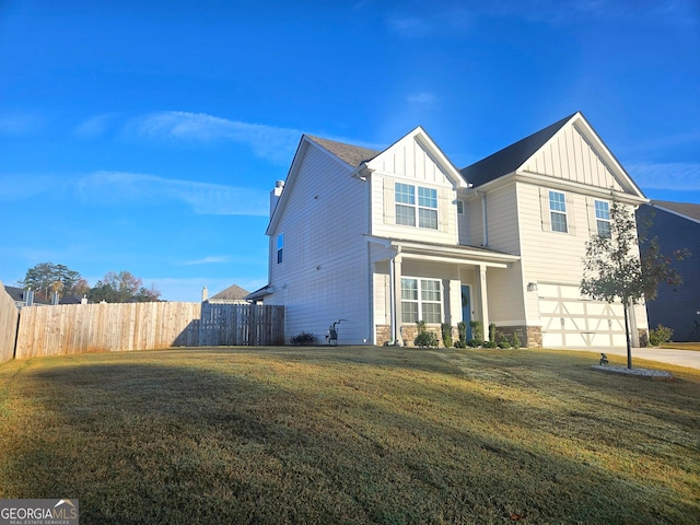 view of front of property featuring a front yard and a garage