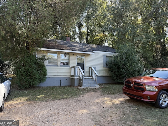 600 S Harlem, Lagrange, GA 30240 - view of front facade featuring crawl space, a shingled roof, and a chimney