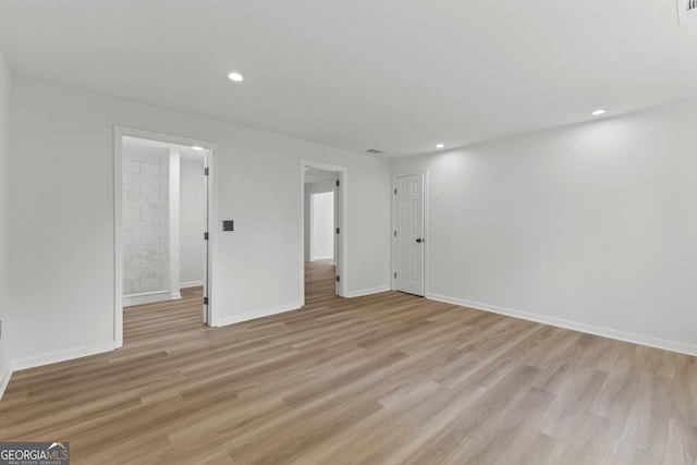 interior space featuring light wood-style floors, visible vents, baseboards, and recessed lighting