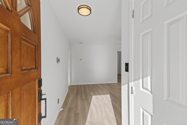 entrance foyer with light wood finished floors and baseboards