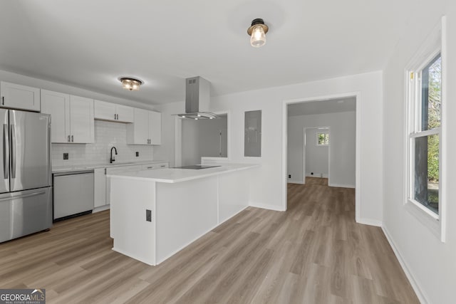 kitchen with white dishwasher, black electric cooktop, island range hood, a sink, and freestanding refrigerator