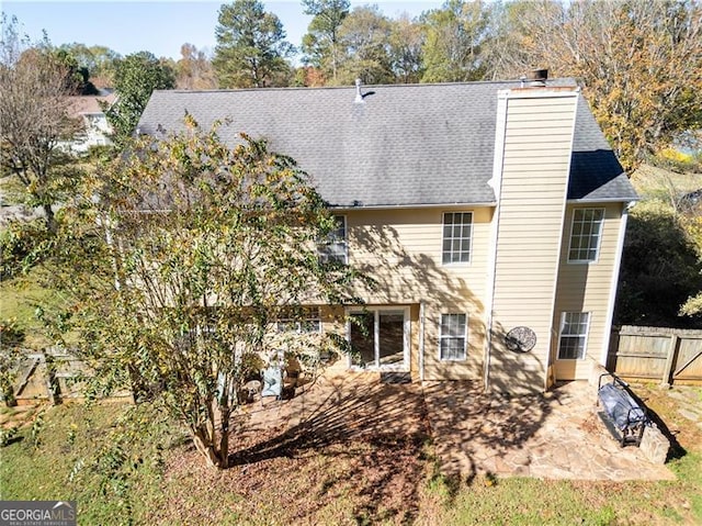 back of property with a patio