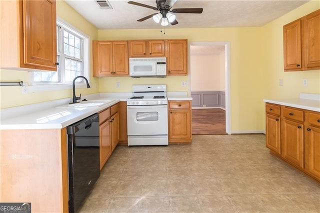 kitchen featuring ceiling fan, sink, and white appliances