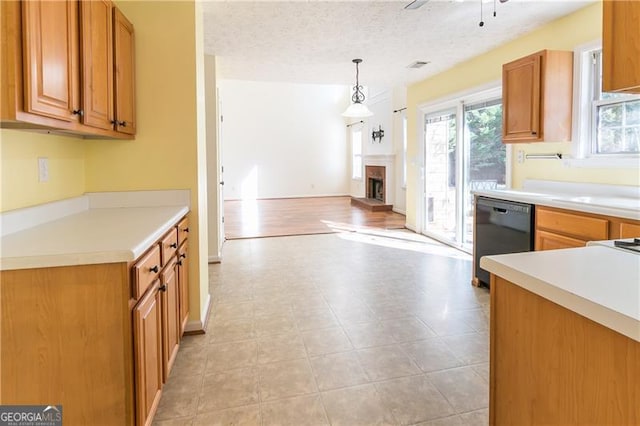 kitchen with dishwasher, pendant lighting, a textured ceiling, and ceiling fan