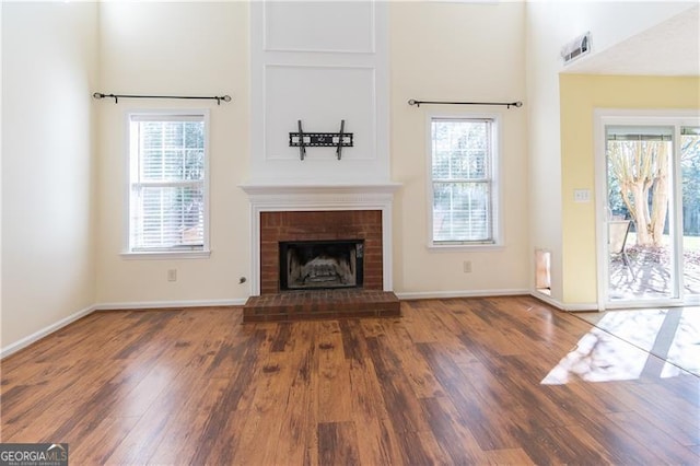 unfurnished living room with a fireplace and dark hardwood / wood-style floors