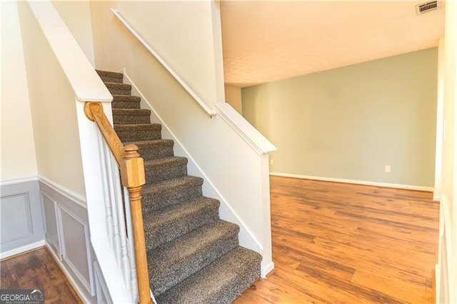 staircase with hardwood / wood-style floors