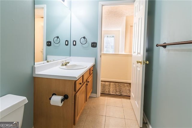 bathroom featuring toilet, vanity, and tile patterned floors