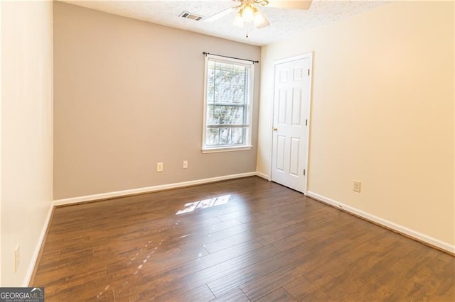 unfurnished room with dark hardwood / wood-style floors and ceiling fan