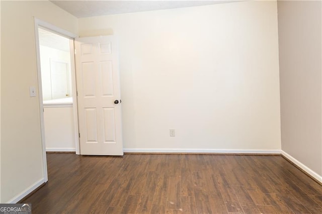 unfurnished room with dark hardwood / wood-style floors