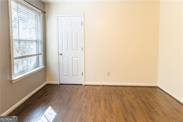 empty room featuring dark wood-type flooring