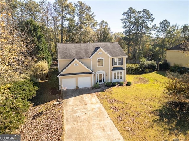 view of front of home with a garage and a front yard