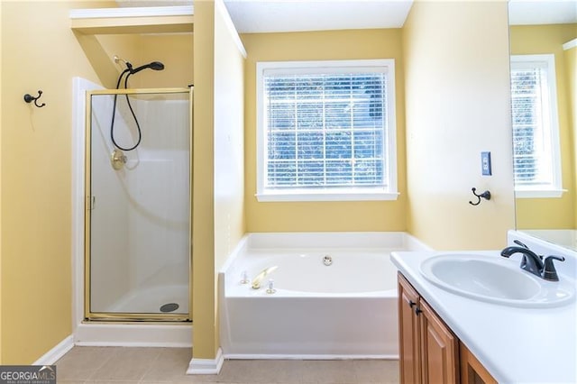 bathroom with tile patterned flooring, shower with separate bathtub, and vanity