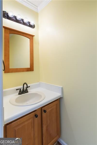 bathroom featuring vanity and ornamental molding