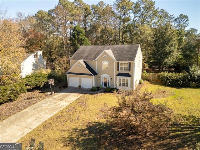 view of front of home with a garage and a front yard