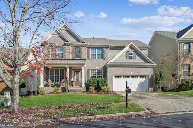 view of front of property featuring a front lawn, covered porch, and a garage