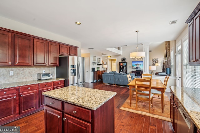 kitchen with a center island, dark hardwood / wood-style flooring, and stainless steel appliances