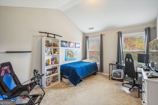 bedroom with lofted ceiling, light carpet, and multiple windows