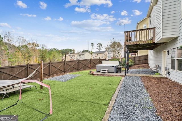 view of yard featuring a deck and a hot tub