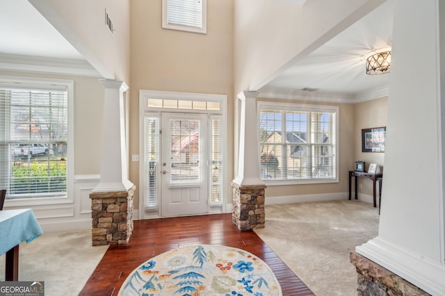 foyer entrance featuring dark carpet and a wealth of natural light