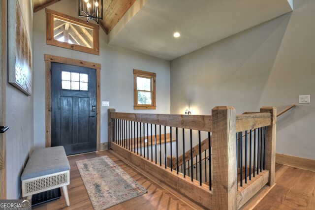 entryway with wood-type flooring and a chandelier