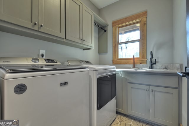 washroom with separate washer and dryer, sink, and cabinets