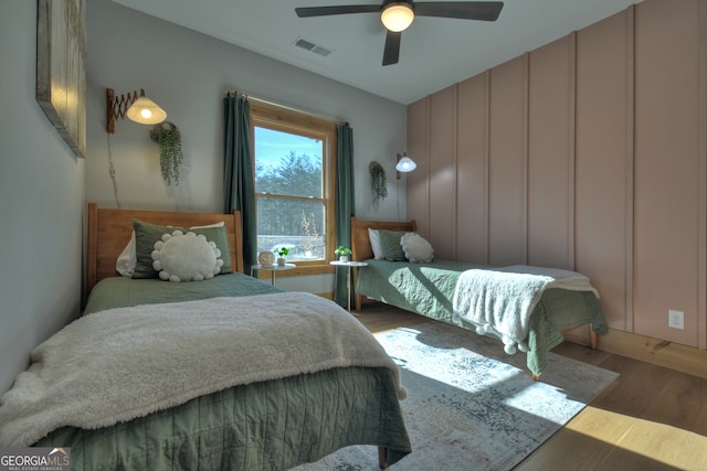 bedroom with ceiling fan and hardwood / wood-style floors