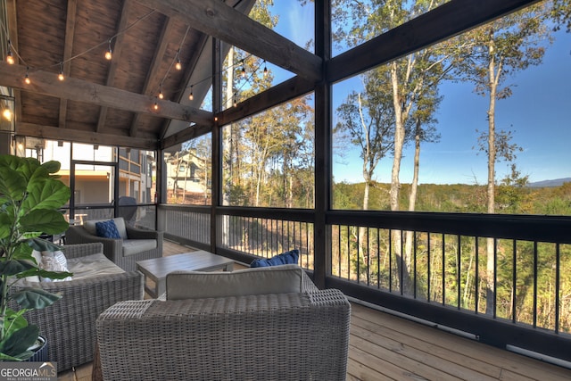 sunroom with lofted ceiling with beams and wood ceiling