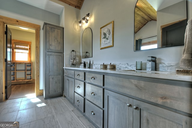 bathroom featuring vanity, vaulted ceiling with beams, and hardwood / wood-style flooring