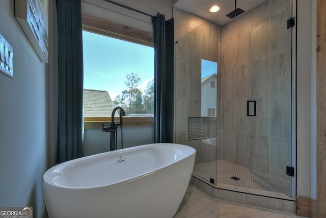 bathroom featuring tile patterned floors and separate shower and tub