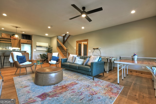 living room featuring hardwood / wood-style flooring and ceiling fan