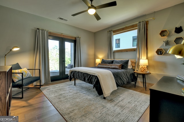 bedroom featuring ceiling fan, light hardwood / wood-style floors, access to outside, and french doors