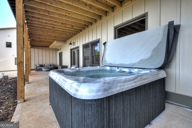 view of patio with an outdoor living space and a hot tub