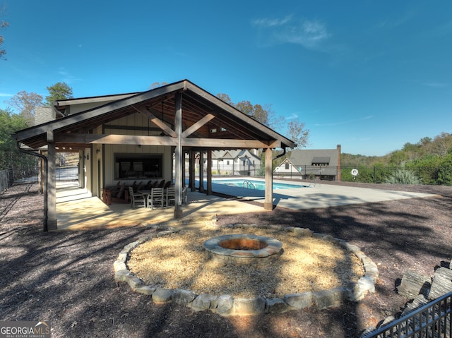 exterior space featuring an outdoor fire pit, a patio area, and a swimming pool