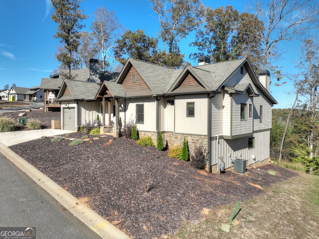 view of front of house with cooling unit and a garage