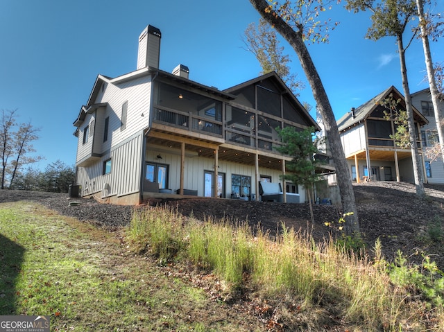 rear view of house featuring central AC unit