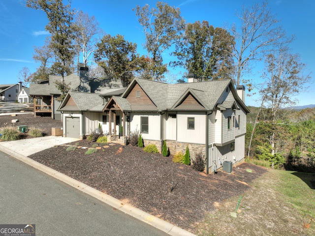 view of front of home featuring a garage and central AC unit