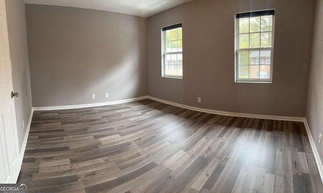 spare room with dark hardwood / wood-style floors