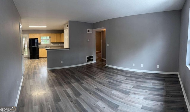 unfurnished living room with dark hardwood / wood-style flooring