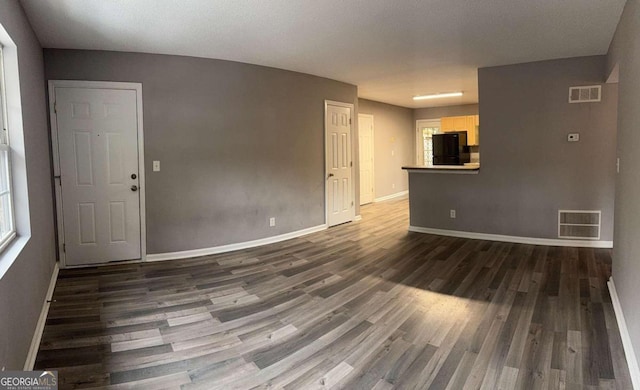 unfurnished living room with dark hardwood / wood-style flooring