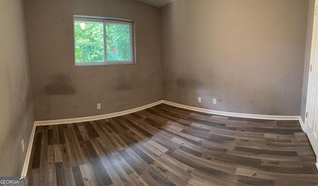 empty room featuring dark hardwood / wood-style flooring