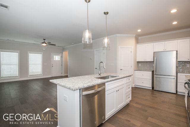 kitchen with white cabinets, appliances with stainless steel finishes, dark hardwood / wood-style floors, and sink